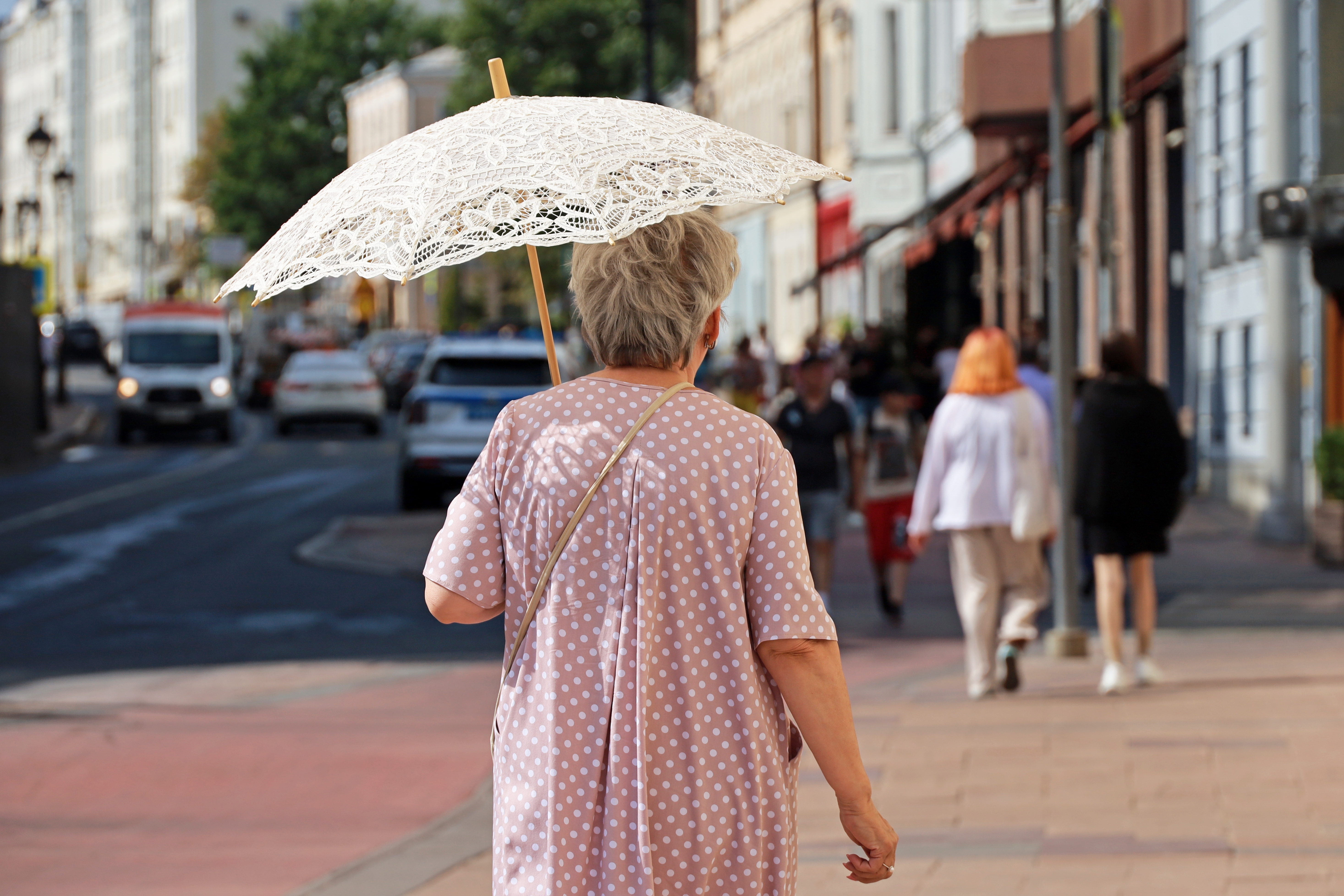 Elderly lady with sun parasol